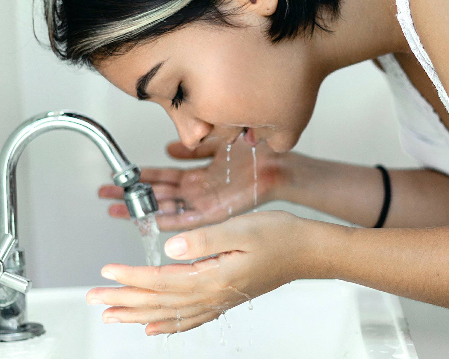 Woman washing her face